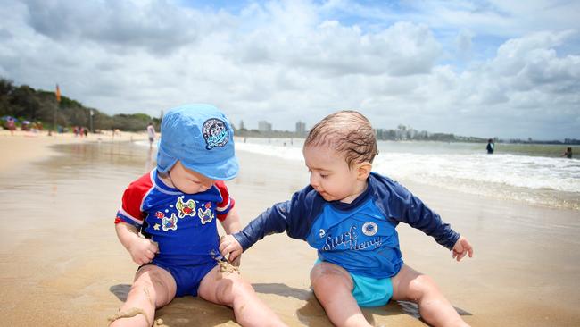 Cousins from Brisbane L-R Riley Smit 11 months and Ethan Howie, 9 months enjoy their first Christmas holiday together at the beach in Mooloolaba in 2011.