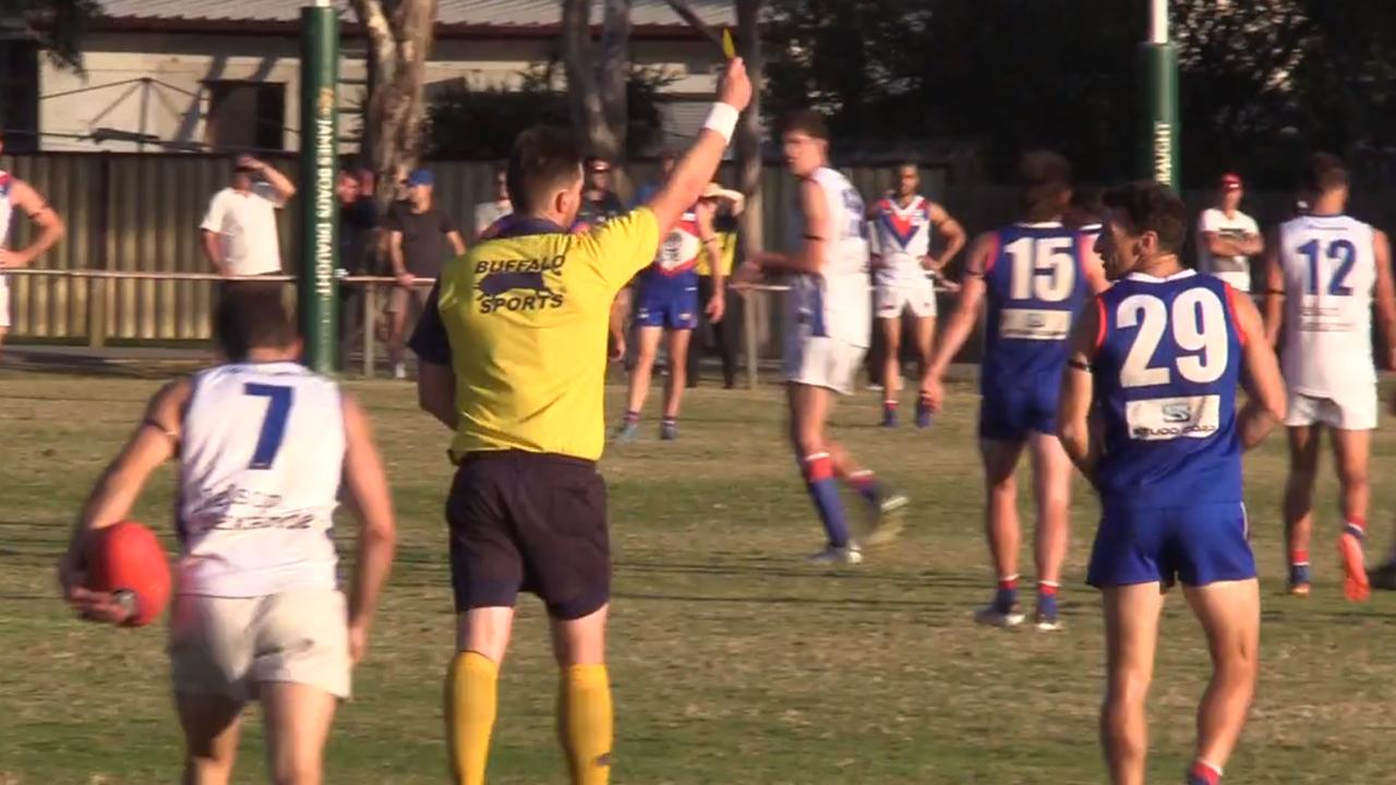 Brent Harvey is show a yellow card for dissent.