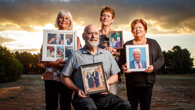 Sandi Todd, holding a photo of her husband Mal, Stephen Lavender, with a picture with his wife Linda, Veronica Leaney, with her husband Roger’s picture and Elisabetta Ferraro with her husband Frank’s. Picture Matt Turner