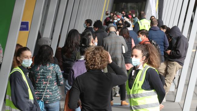 Staff turn people away at the end of the queue at the Melbourne Convention Centre vaccination site on Saturday. Picture: David Crosling