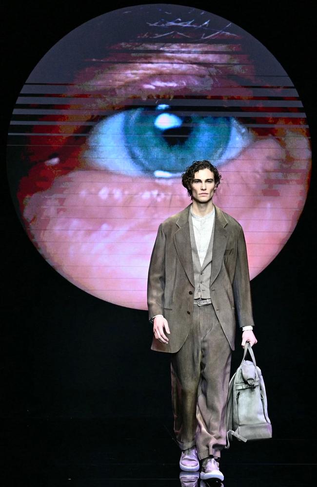 A model walks the runway at Milan Fashion Week, showcasing the Giorgio Armani Menswear Autumn/Winter 2024/2025 collection under a watchful eye. Picture: Gabriel Bouys/AFP