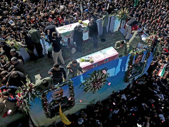 Iranian mourners gather around the vehicle carrying the coffin of the slain general in his hometown Kerman. Picture: AFP