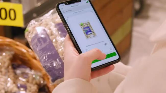 Shoppers use their mobile phone to scan items as they shop.