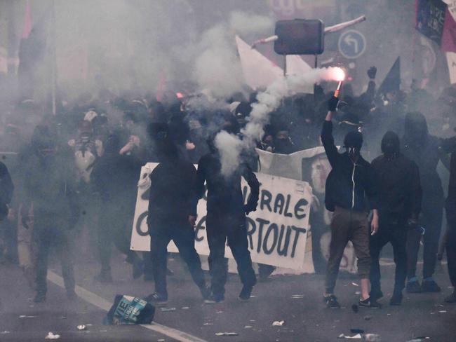 A protester lights a flare during a demonstration. Picture: AFP/Alain Jocard