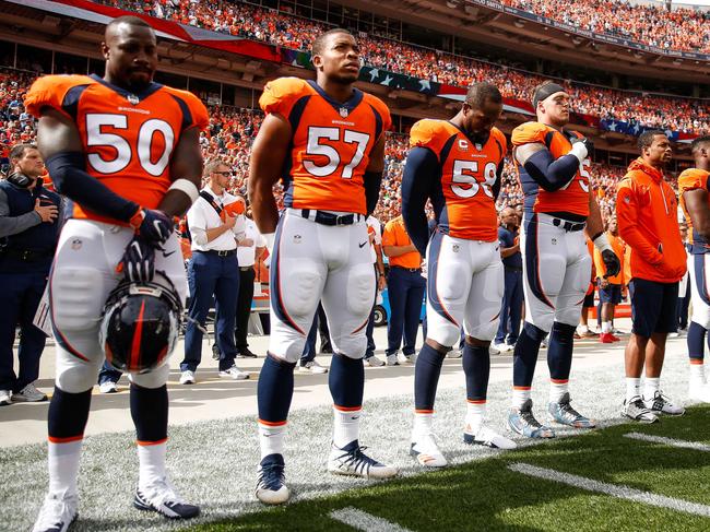 DENVER, CO - OCTOBER 1: Denver Broncos players stand during the national anthem before a game against the Oakland Raiders at Sports Authority Field at Mile High on October 1, 2017 in Denver, Colorado.   Justin Edmonds/Getty Images/AFP == FOR NEWSPAPERS, INTERNET, TELCOS & TELEVISION USE ONLY ==