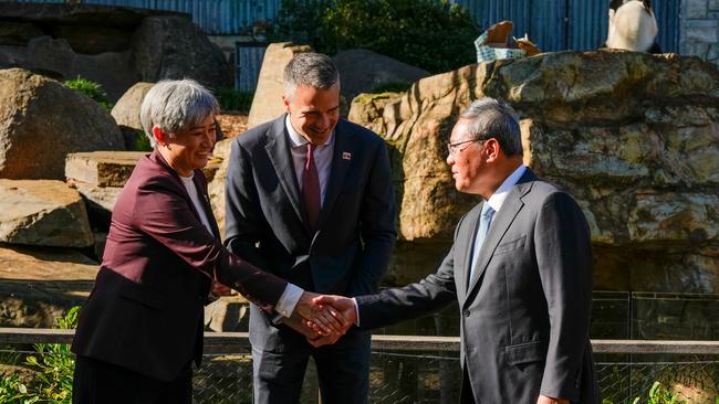 ADELAIDE, AUSTRALIA - JUNE 16: Australia's Foreign Minister Penny Wong (L) shakes hands with China's Premier Li Qiang at as South Australian Premier Peter Malinauskas (C) looks on Adelaide Zoo on June 16, 2024 in Adelaide, Australia. Li's visit to Australia aims to strengthen bilateral ties and address outstanding trade and consular issues, including the removal of remaining trade barriers and the release of imprisoned Australian democracy blogger Yang Hengjuno, marking a significant step towards stabilizing the relationship between the two nations. The visit also highlights the growing importance of economic cooperation and the need for dialogue on security concerns, particularly in the context of China's increasing influence in the Pacific region. The visit marks the first high-level diplomatic by a Chinese leader to Australia since 2017. (Photo by Asanka Ratnayake/Getty Images)