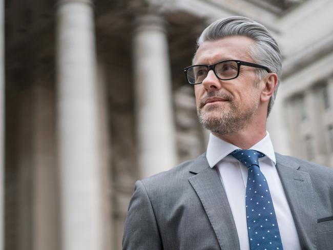 Successful business man or lawyer walking on the street wearing eyeglasses. Picture: iStock