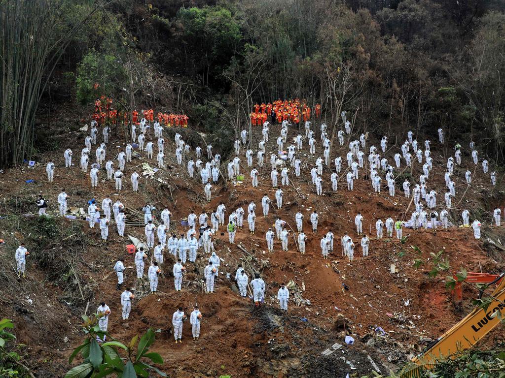 Rescuers standing in a silent tribute for victims at the site of the China Eastern Airlines flight MU5375 plane crash in Tengxian county, Wuzhou city, in China's southern Guangxi region. Picture: AFP