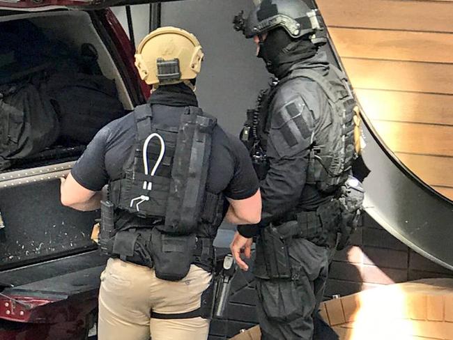 Special operations group police during yesterday’s operation. Picture: Paul Dowsley/Seven News