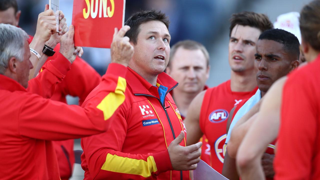 Gold Coast coach Stuart Dew talks to his players.