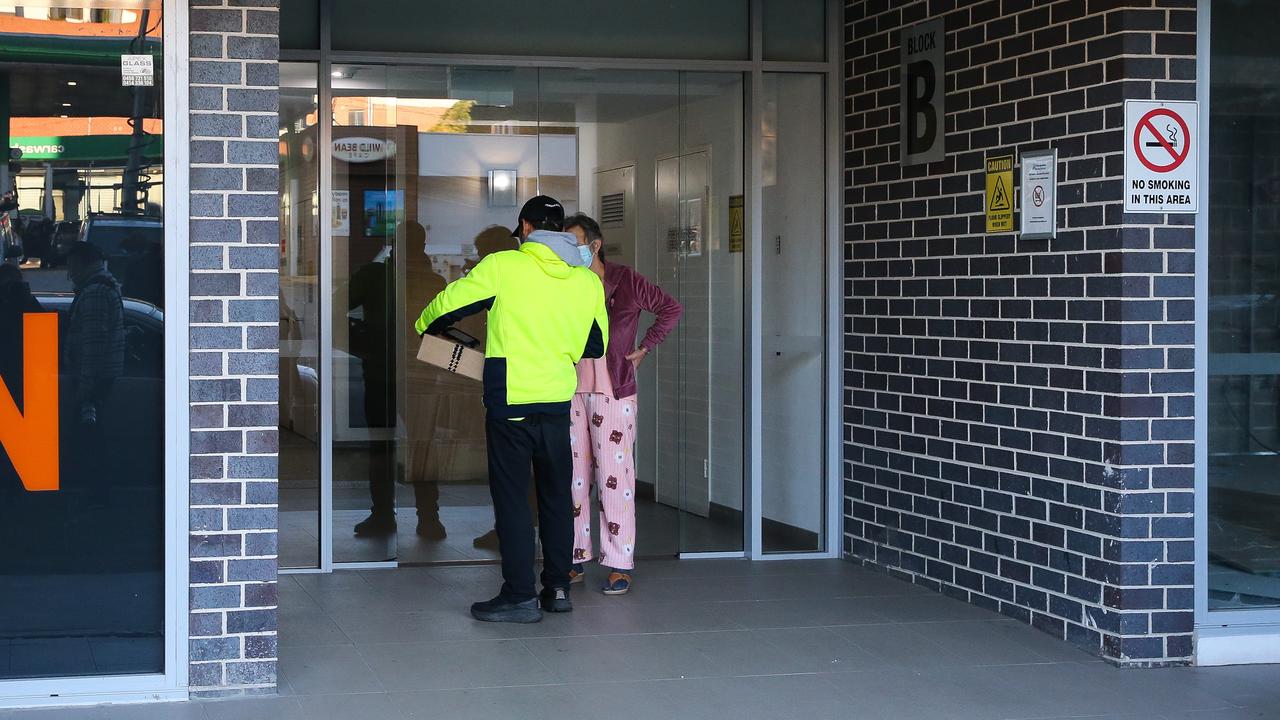 A courier was seen delivering a parcel to the Canterbury apartment building after the bodies of two women were located inside one of the units. Picture: NCA Newswire/ Gaye Gerard.