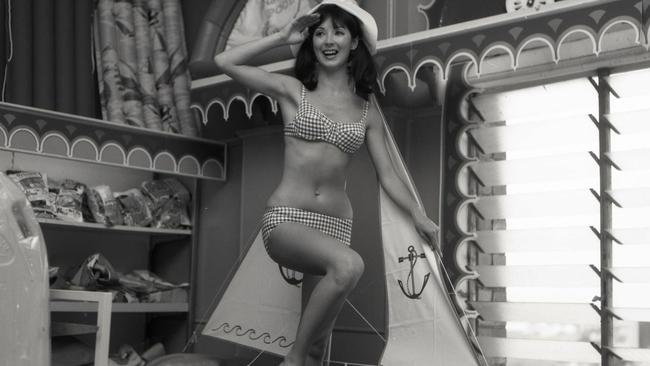 1968: “Michele Power models swimsuits at McWhirters. Salute to sail, sun and surf fashions from Michelle Power who paraded at McWhirters the Valley, against a background of a small sailing (boat). Michelle was wearing a red and white checked gingham bikini and floppy white cotton hat.” Picture: Bob Nicol/ The Courier-Mail Photo Archive