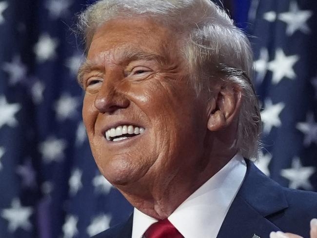 Republican presidential nominee former President Donald Trump stands on stage with former first lady Melania Trump, as Lara Trump watches, at an election night watch party at the Palm Beach Convention Center, Wednesday, Nov. 6, 2024, in West Palm Beach, Fla. (AP Photo/Evan Vucci)