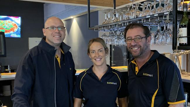 As Woodburn tries to get back on its feet, business owner Daniel Simpson (left) and staff members Tegan Marritt and James Kerr are happy to be reopened.