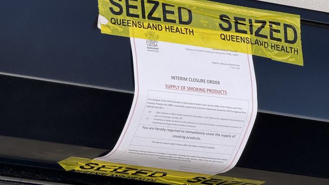 A Queensland Health closure notice taped to the front of Kirwan Tobacconist, ordering an immediate halt to the supply of smoking products. The store was shut down as part of a crackdown on illicit tobacco and vaping sales. Picture: Natasha Emeck