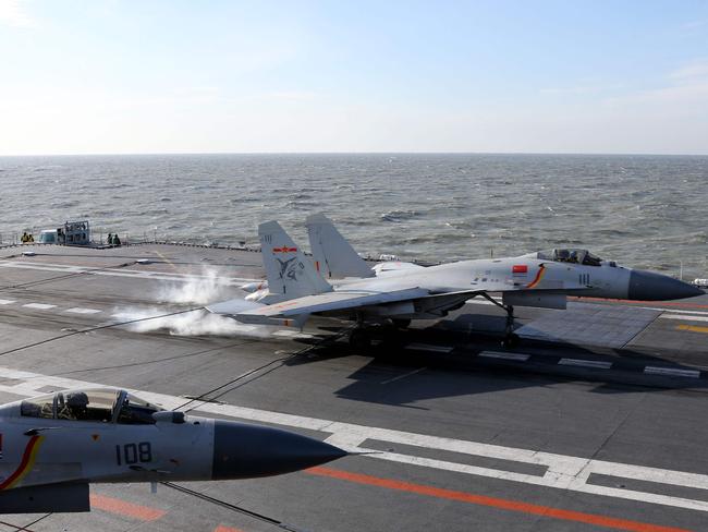 A Chinese J-15 fighter jet lands on the deck of the Liaoning aircraft carrier during military drills in the Bohai Sea, off China's northeast coast in December. China’s navy plans a training exercise in the Pacific that would include for the first time its sole aircraft carrier, a move likely to ratchet up regional tensions.