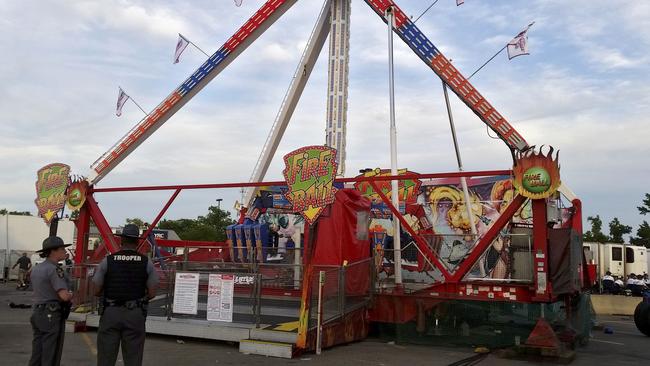 Authorities stand near the Fire Ball amusement ride after the ride malfunctioned at the Ohio State Fair. Picture: AP