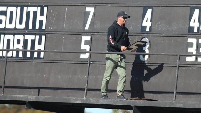 Crows premiership player Clay Sampson operating the Noarlunga Oval scoreboard during the South-North clash on Sunday. Picture: Dean Martin.