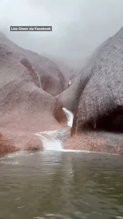 Stunning Uluru sight as rain smashes country