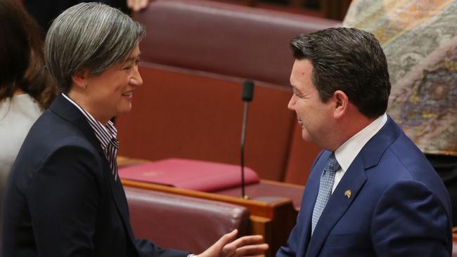 Senator Penny Wong shakes hands with Senator Dean Smith after his speech on the Marriage equality bill in the Senate at Parliament House in Canberra. Picture: Kym Smith.