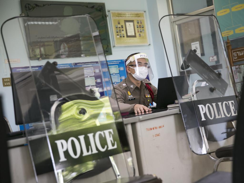 Thai police work on social distancing practices as the country imposes strict rules to deal with the crisis.