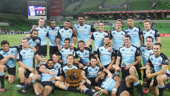 Waratahs players pose with the Weary Dunlop Shield at AAMI Park.