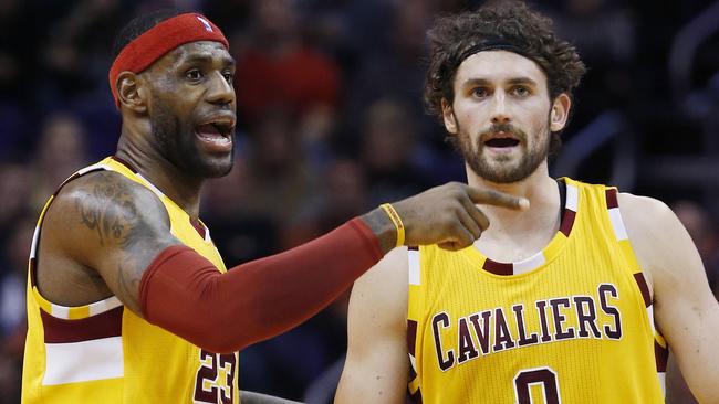 Cleveland Cavaliers' LeBron James and Kevin Love talk after a timeout during the first half.