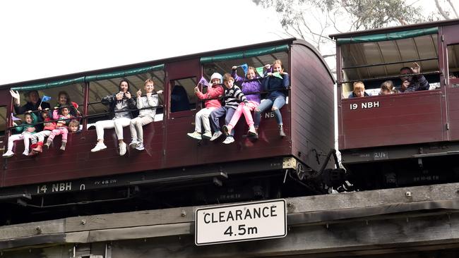 Children love to dangle their legs out of Puffing Billy’s carriages. Picture: Mike Keating