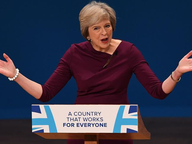 British Prime Minister Theresa May gestures as she delivers a keynote address on the final day of the annual Conservative Party conference at the International Convention Centre in Birmingham, central England, on October 5, 2016. Brexit prompted the resignation of the UK's prime minister and the reshaping of the country's government, but the ruling Conservative Party has already rebounded and is showing a united front. The jubilant mood at the annual Conservatives conference is being led by its hardline eurosceptics -- for years the awkward squad within the party. / AFP PHOTO / PAUL ELLIS