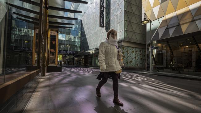 A woman is seen in an almost empty Little Bourke Street in Melbourne on Sunday. Picture: NCA NewsWire / Daniel Pockett