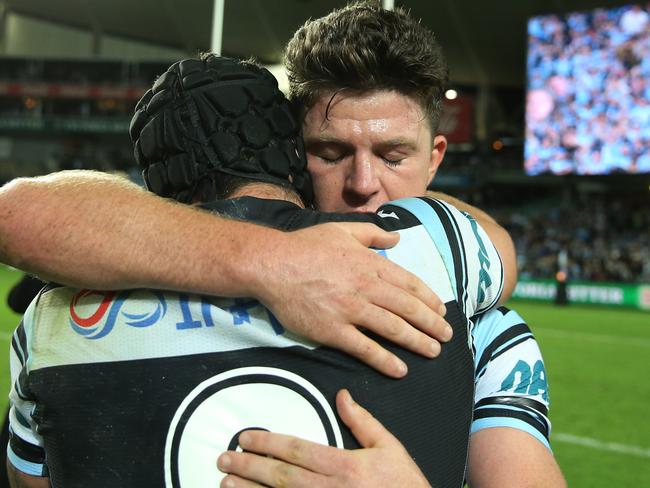 Chad Townsend and Michael Ennis hug after the NRL preliminary final.