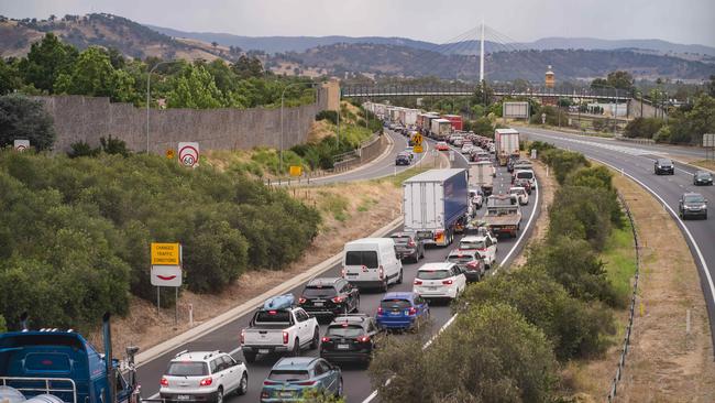 Cars and trucks wait to cross the border into Victoria on the Hume Freeway in Albury. Picture: Simon Dallinger