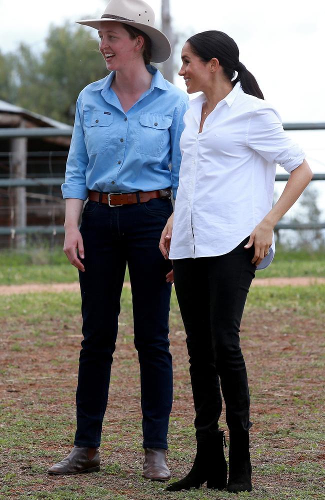 Meghan gets her jacket off for the farm visit to the sheep and cattle property of Laura Woodley (left). Picture: Toby Zerna.