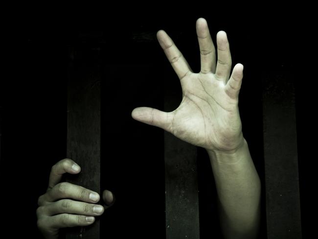 let me out, hands holding bars, green light, mental health generic, thinkstock, trapped, asylum seeker, young hands, unhappiness, sadness, depression, reaching for help, helpless