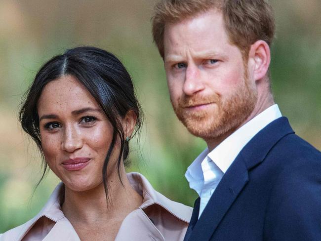 TOPSHOT - Britain's Prince Harry, Duke of Sussex(R) and Meghan, the Duchess of Sussex(L) arrive at the British High Commissioner residency in Johannesburg where they  will meet with Graca Machel, widow of former South African president Nelson Mandela, in Johannesburg, on October 2, 2019. - Prince Harry recalled the hounding of his late mother Diana to denounce media treatment of his wife Meghan Markle, as the couple launched legal action against a British tabloid for invasion of privacy. (Photo by Michele Spatari / AFP) / France OUT until 2019-10-17T00:00:00.000+02:00