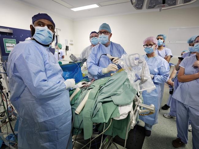 Neurosurgeon Jacob Fairhall starts the removal of the tumour after six hours of drilling by ear nose and throat surgeon Dr Catherine Banks (to his right) to access it. Picture: Sam Ruttyn