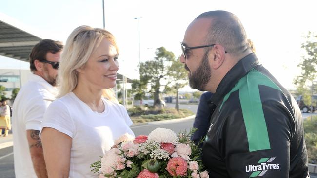 Pamela Anderson is given welcome flowers by her limo driver Jimmy Seoud, of Ultra Tune on arrival into Brisbane Airport before driving her to the Gold Coast. Pictures: Nathan Richter.