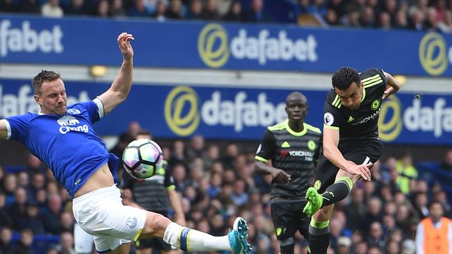 Chelsea's Spanish midfielder Pedro (R) scores the opening goal during the English Premier League football match between Everton and Chelsea.