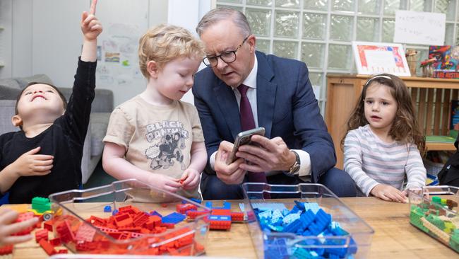 CANBERRA, AUSTRALIA - NewsWire Photos FEBRUARY 9, 2023: L-R: Bradley Gosper, Prime Minister, Anthony Albanese and Olivia Castrisson. The PM was showing Bradley his dog on his phone.Prime Minister, Anthony Albanese with the Minister for Education, Jason Clare, the Minister for Early Childhood Education, Dr Anne Aly and Alicia Payne, the Member for Canberra during a visit to the Manuka Childcare Centre.Picture: NCA NewsWire / Gary Ramage