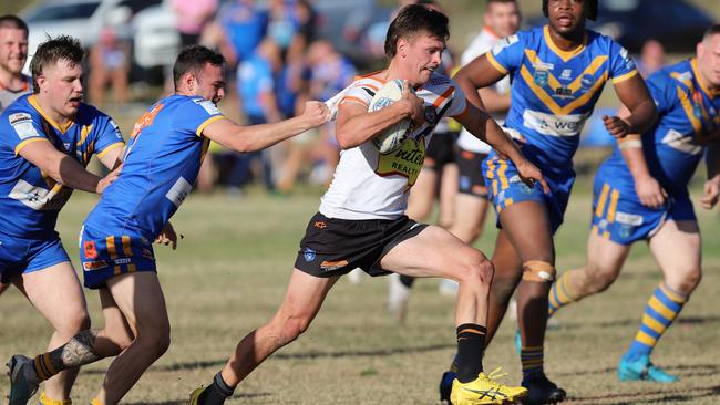 Tigers half Daniel Payne takes on the City defence. Picture: Steve Montgomery