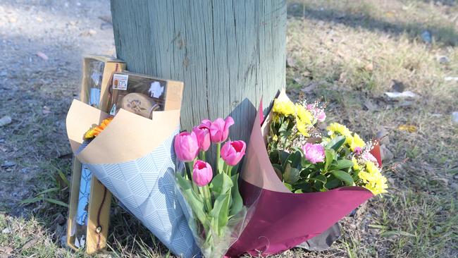 Flowers have been left at the scene of a crash that killed a 19-year-old man. Picture: Richard Gosling