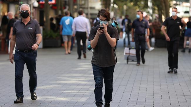 Pedestrians walk down Hay Street Mall in Perth wearing face masks. Picture: Getty