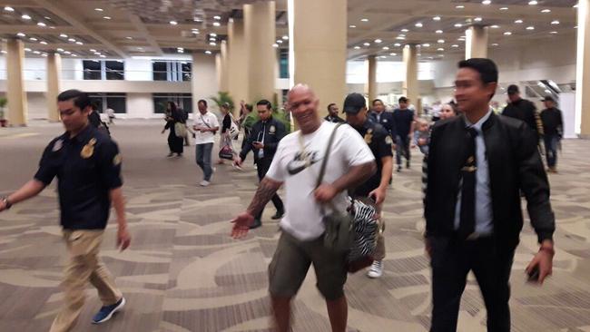 Sent home from Bali.... Radford is escorted back to a plane in Denpasar airport last month.