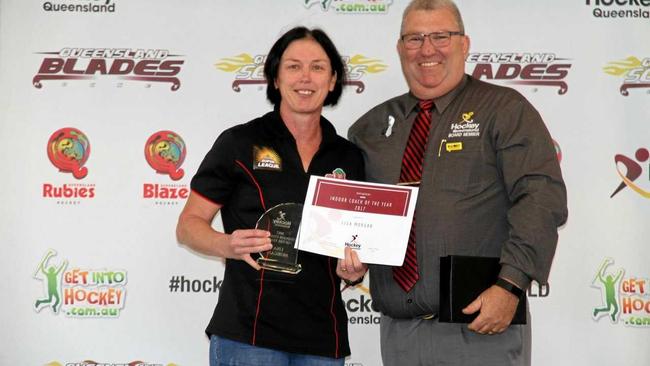 WELL-DESERVED: Rockhampton's Lisa Morgan receives the first of her 2017 Coach of the Year awards from Steve Stewart, president of Hockey Queensland. Picture: CONTRIBUTED