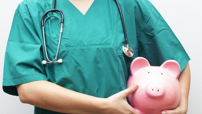 Doctor with piggy bank in hand representing medical costs