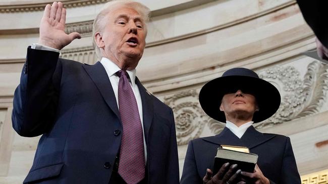 Donald Trump is sworn in as the 47th president as Melania Trump holds the Bible during the 60th Presidential Inauguration. Picture: AFP