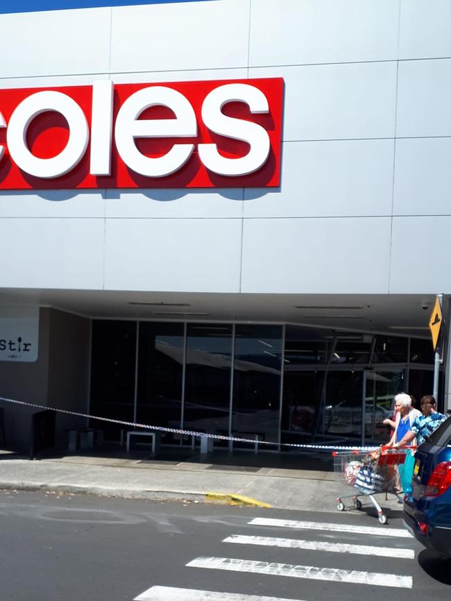 The store entrance has been wrapped in police tape.