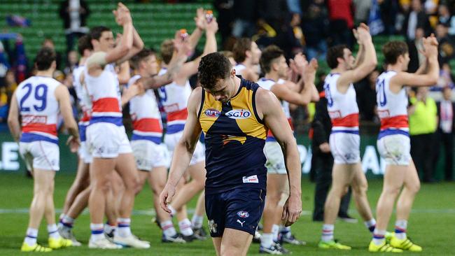 Luke Shuey walks off as the Bulldogs celebrate. Picture: Daniel Wilkins