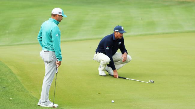 Sergio Garcia looks on as Matt Kuchar lines up a putt at the World Golf Championships Match Play. Picture: Getty