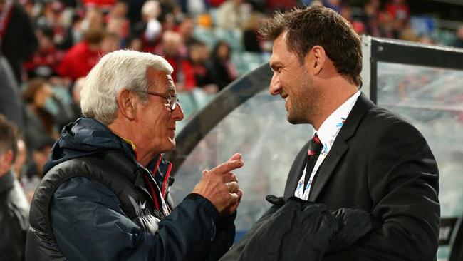 Guangzhou Evergrande coach Marcello Lippi talks to Wanderers boss Tony Popovic.